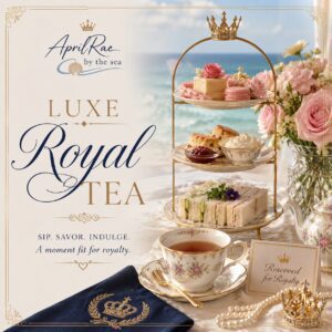 Three-tiered pastry stand and teacup by sea